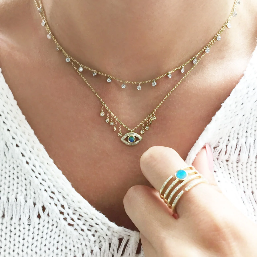 Diamond bezel necklace layered on model with evil eye necklace