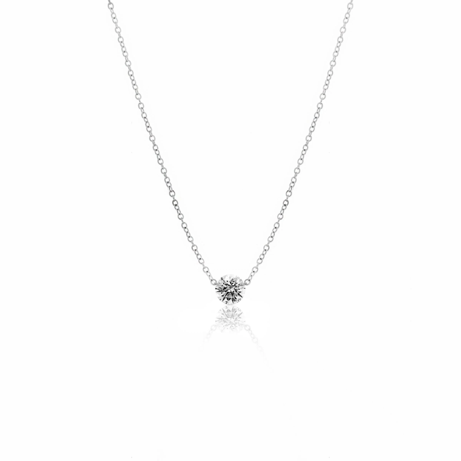 Solitaire diamond necklaces layered on model