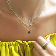 White Gold Dainty Cross and Bezel Diamond Necklace layered on model