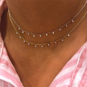 Diamond bezel chokers layered on model